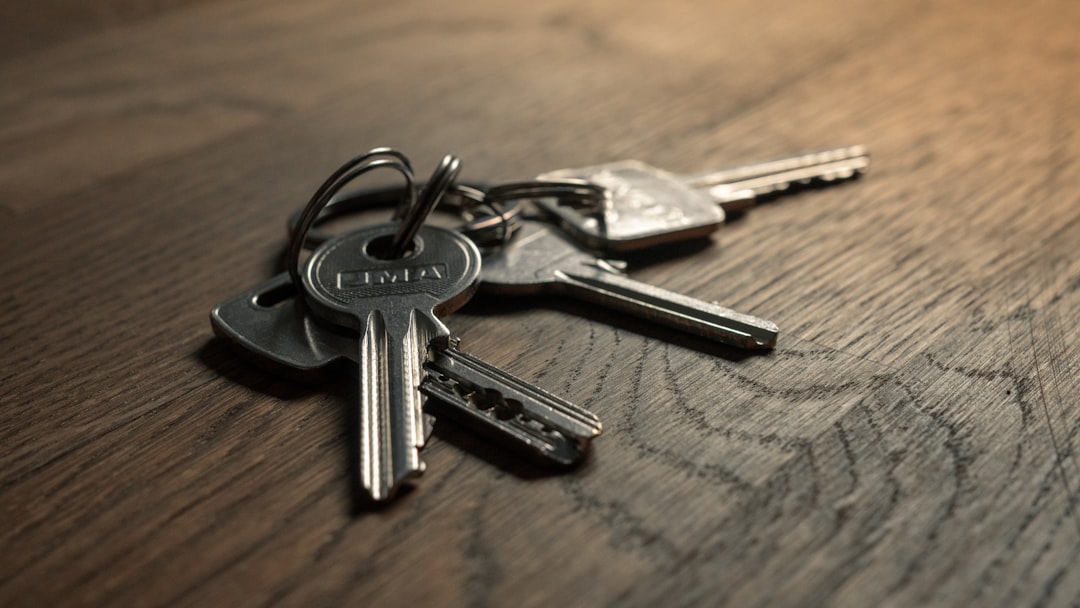 A set of metal keys on a wooden surface.